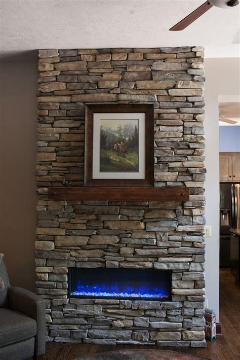 Cast stone is a very popular material for fireplaces because of its finish. custom stacked stone fireplace - Pinnacle Homes, Inc.