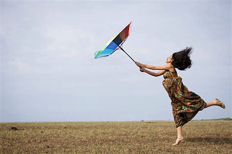 Woman Flying Away With Umbrella In A Storm Stock Photos Pictures