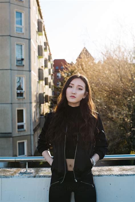 Sunny Outdoor Portrait Of Cool Mongolian Girl In Black Bomber Jacket By