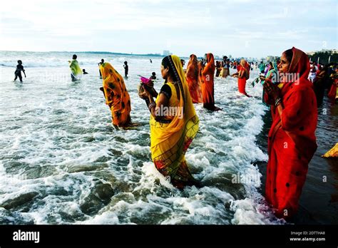 Indian Hindu Devotees Offer Prayers To The Sun On The Occasion Of