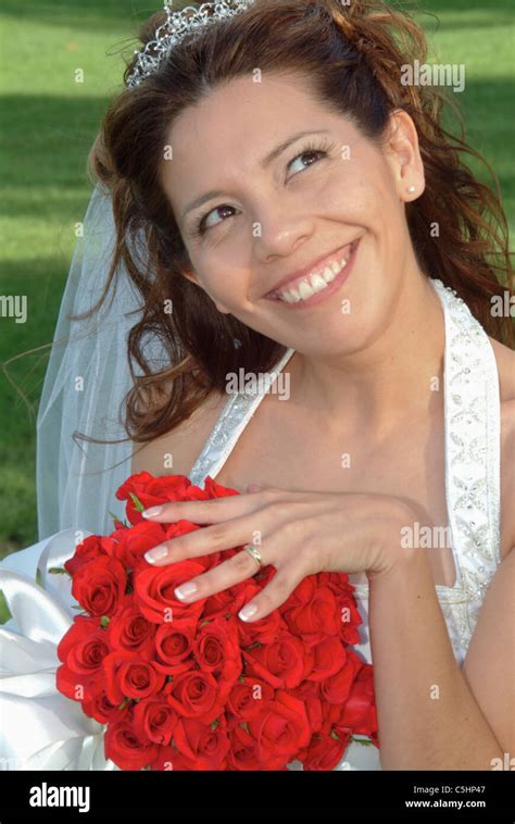 A Bride Shows Off Her Wedding Ring And Flowers With A Silly Grin On Her