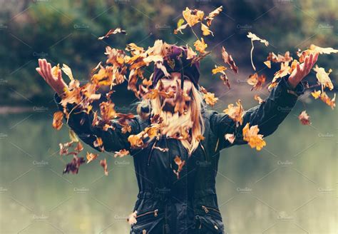 Woman Playing With Autumn Leaves People Photos Creative Market