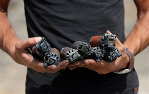 A Palestinian Protester Holds Empty Tear Gas Canisters Fired By Israeli