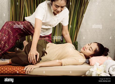 Young Asian Girl Get Thai Style Massage By Woman For Body Therapy Stock