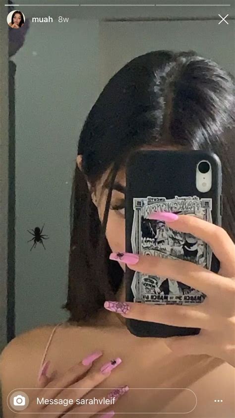 A Woman Taking A Selfie In The Mirror With Her Cell Phone And Pink Nail