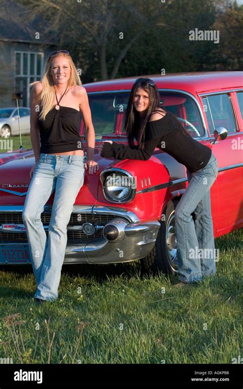 Two Young Girls Beautiful Women Leaning On A Red 1955 Chevy Car