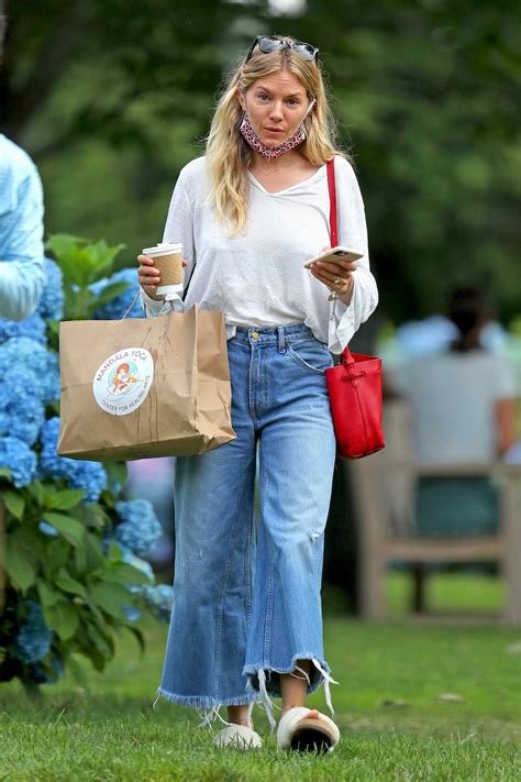 Sienna Miller Wears A White Top And Flared Jeans As She Steps Out For A