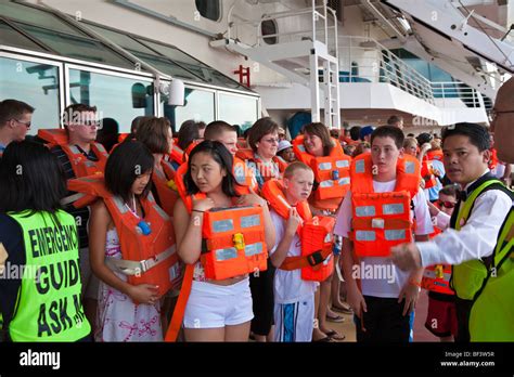 Cruise Ship Passengers With Life Vests Perform Mandatory Muster Stock