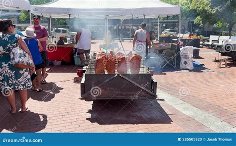 People Watching Meat Being Cooked Over Coals At A Hawaiian Festival
