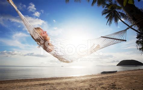 Young Woman Relaxing In A Hammock At The Tropical Beach Stock Photo