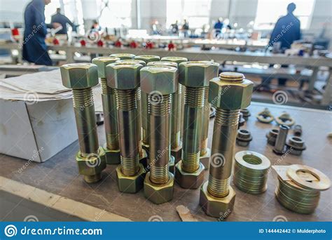 Large Bolts With Screwed Nuts In Metalworking Factory Stock Photo
