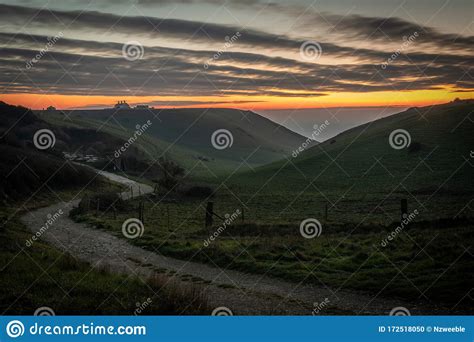 Beautiful Vibrant Sunset Over Country Road And Clifftop Stock Photo