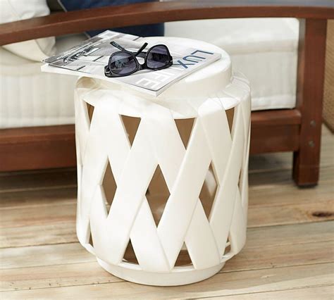Wood constructed with white lacquer finish, the cabinet/tables are comprised of a rectangular top over a single drawer with open shelf below, flanked with turned supports. Lattice Ceramic Accent Table | Pottery Barn AU