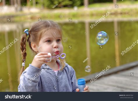 Adorable Little Girl Blowing Bubbles Park Stock Photo 688587454
