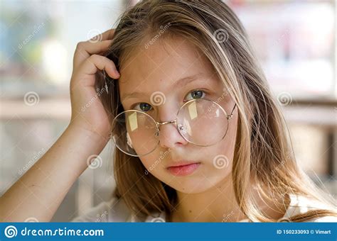 Portrait Of Stylish Smiling Teen Girl With Glasses In Caffee Stock