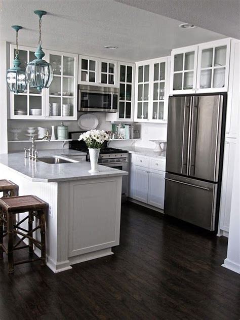White kitchen cabinets are classic and usually a safe design decision. Kitchen - white cabinets, dark hardwood floors, white/gray ...