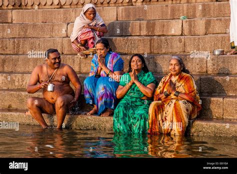 hindu pilgrims praying and bathing in the holy river ganges varanasi uttar pradesh india