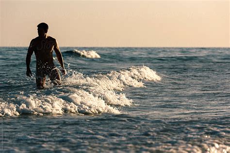 Naked Man In The Beach Of Fuerteventura Spain by Stocksy Contributor Santi Nuñez Stocksy