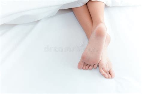 woman feet on the bed under white blanket sleeping and relax concept stock image image of