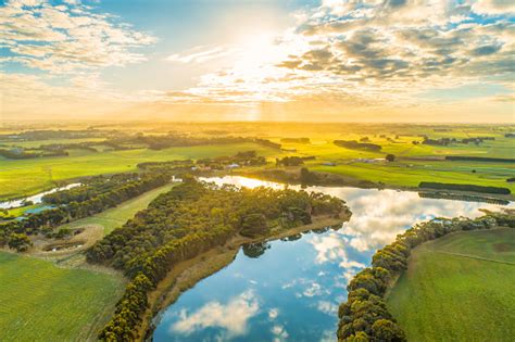 Aerial Landscape Of Sunset Over River In Rural Area Stock Photo