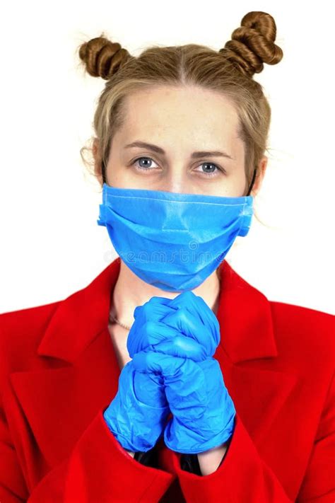 A Young Girl In A Medical Protective Mask And Latex Gloves Prays