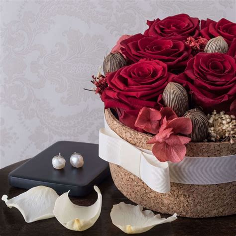 Accented with assorted greenery artistically designed in a clear glass vase Shades of Love - Preserved Roses | Preserved roses ...