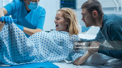 In The Hospital Woman In Labor Pushes To Give Birth Obstetricians