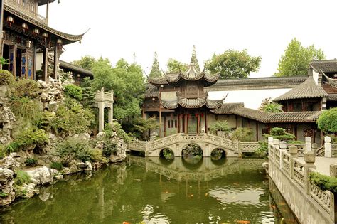Traditional Chinese Garden With Fish Pool Stone Bridge And Pavilions