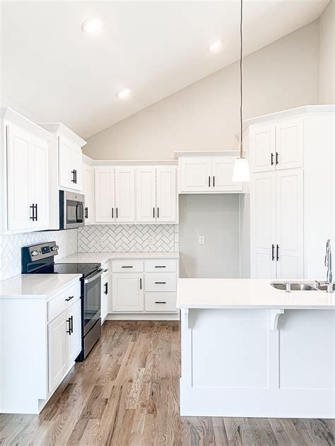 Stunning White Kitchen With White Subway Tile And Black Hardware White