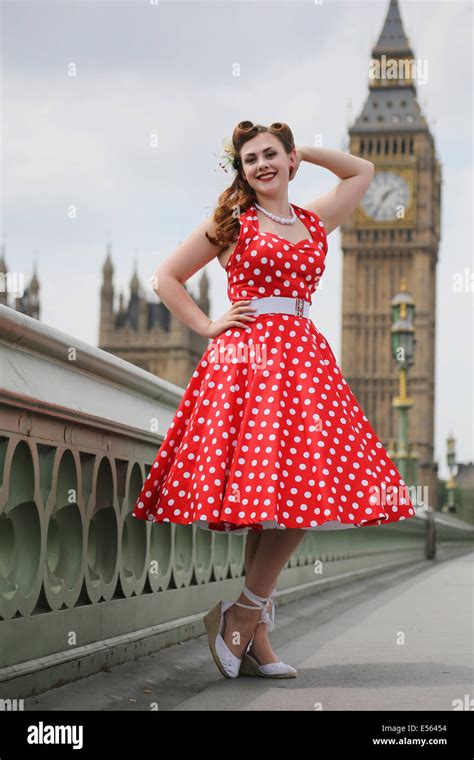 Woman In Bright Red Polka Dot Dress Standing On Westminster Bridge