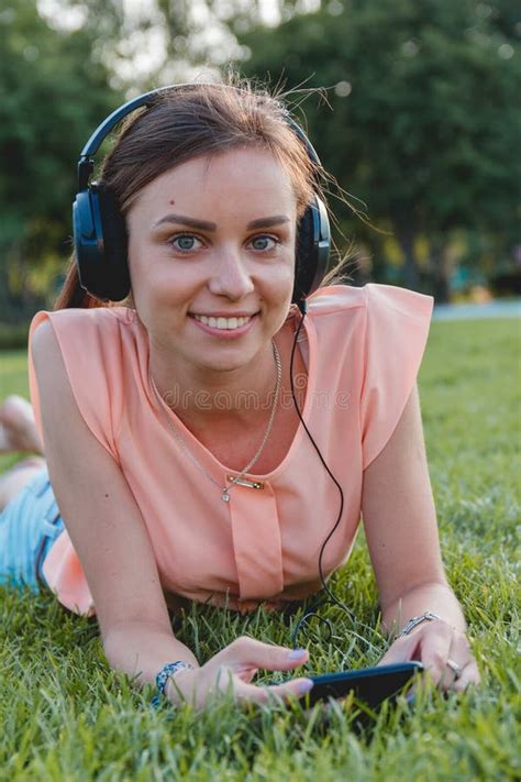 Portrait Of Young Attractive Girl Listening To Music With Headphones