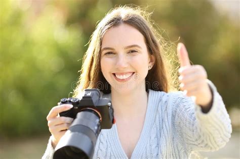 Happy Photographer Gesturing Thumb Up In A Park Stock Photo Image Of