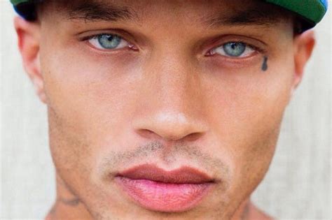 A Close Up Of A Person Wearing A Baseball Cap With Tattoos On His Face