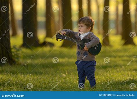 Little Boy Play Guitar In Forest Stock Photo Image Of Love Autumn