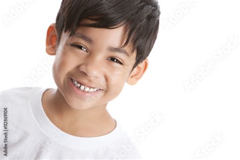 Portrait Of A Smiling Mixed Race Boy Isolated On White With Room For