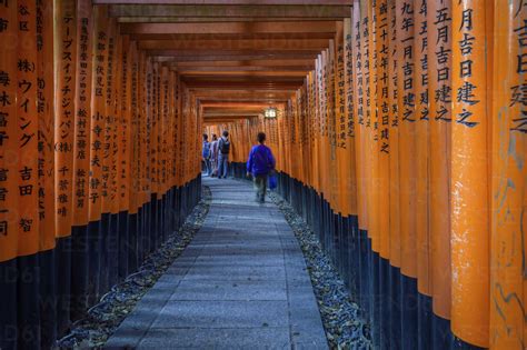 People Walking Through Red Torii Gates Kyoto Japan Stock Photo