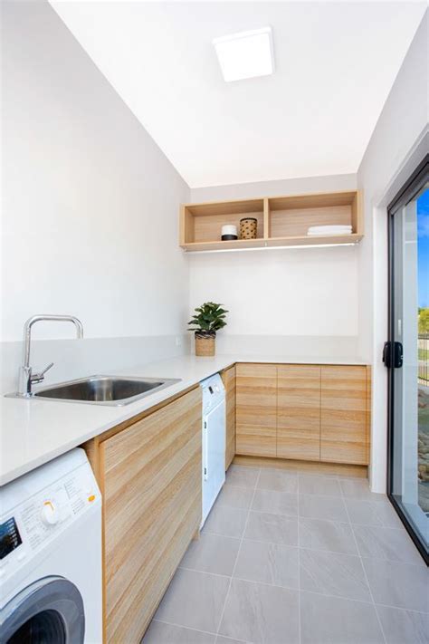 This laundry room design incorporates elements of a home office. Beautiful modern looking laundry in polytec Natural Oak ...
