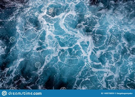 rough deep turquoise and blue mediterranean sea with white foam texture background stock image