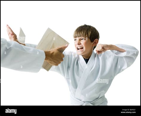 Boy Breaking A Board Using Karate Stock Photo Alamy