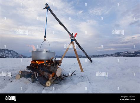 Cooking On A Camp Fire In A Hanging Dutch Oven Ice Of Frozen Lake