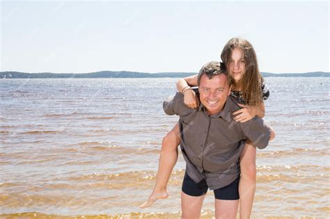 Padre E Hija Adolescente Jugando En La Playa Durante El Día Concepto