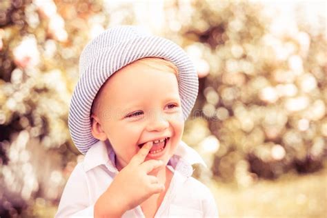 Child On The Green Grass In Summer Park Baby Face Closeup Funny