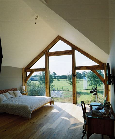 A classy bedroom featuring a vaulted ceiling with exposed beams and elegant carpet flooring. Oak frame and glazing, vaulted ceiling bedroom www ...