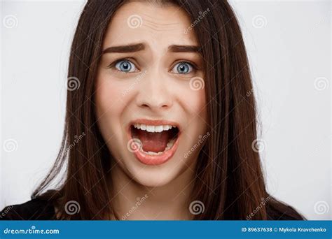 Close Up Portrait Of Beautiful Scared Brunette Girl Shouting In Camera