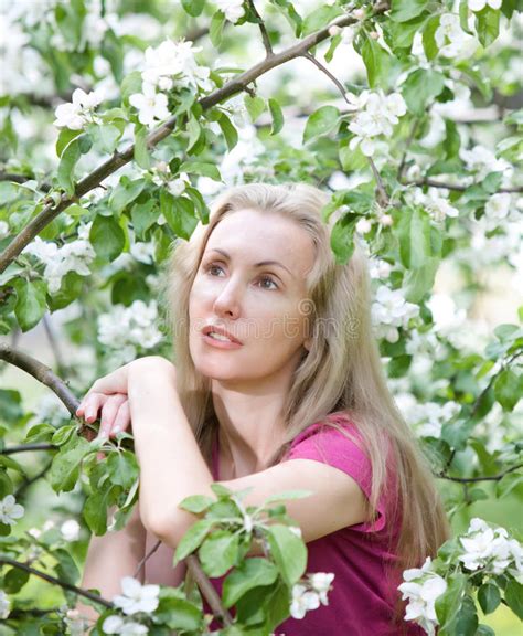 Young Attractive Woman Standing Near The Blossoming Apple Tree Stock Image Image Of Blossom