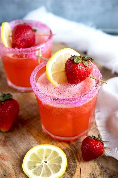 Two Glasses Of Refreshing Strawberry Lemonade Vodka Cocktail Garnished With Fresh Strawb