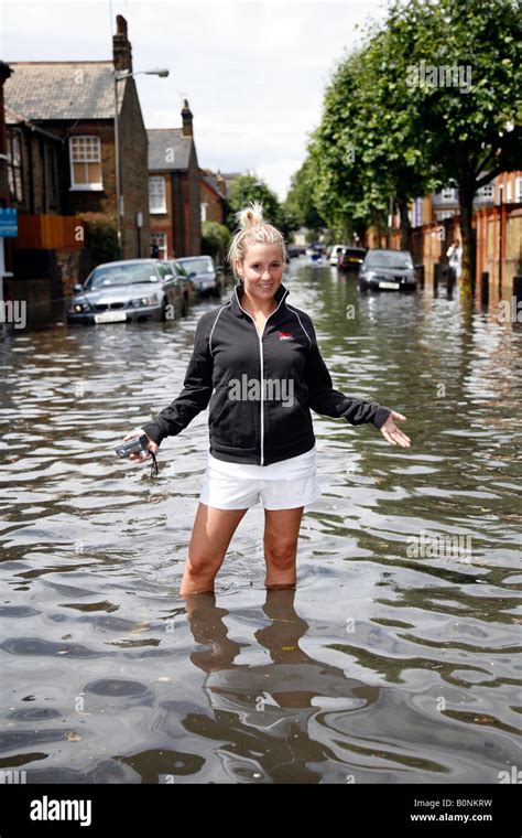 Portrait Of A Young Woman Standing In Floodwater Flood On The Road
