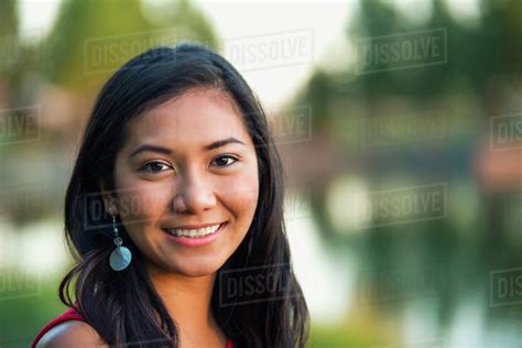Portrait Of A Beautiful Young Filipino Woman Smiling In A City Park In Autumn St Albert
