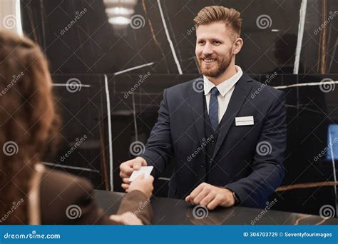 Smiling Man At Hotel Reception Desk Welcoming Guest Stock Image Image