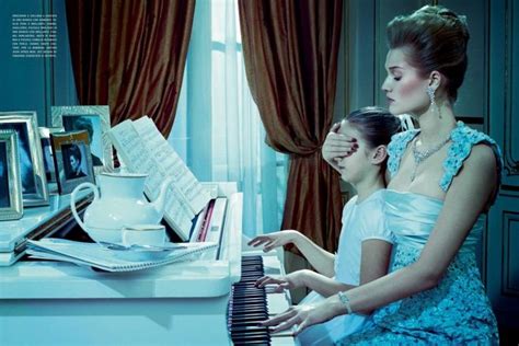 Two Women Sitting At A Piano In Front Of A Window